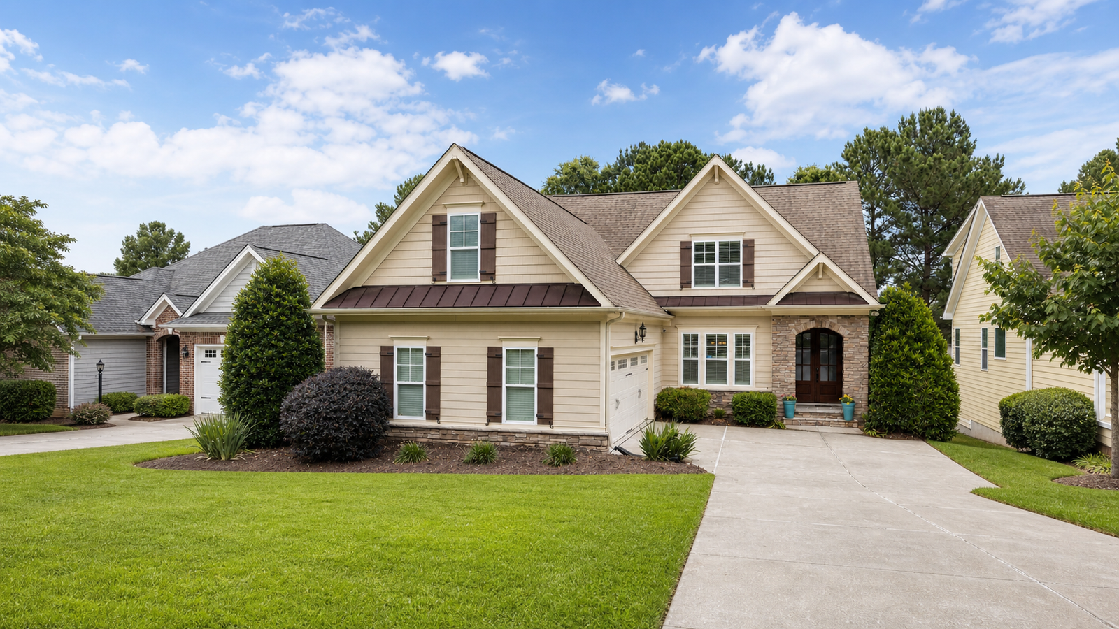 A polished suburban home with a manicured lawn and clean driveway